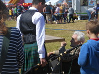 Norman Maclean talking to a piper at the North Uist Games by Norman Macleod is  in copyright